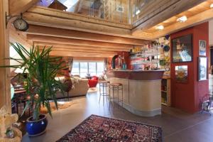 a kitchen with a bar and a living room at Les Fermes De Pinpin in Labaroche