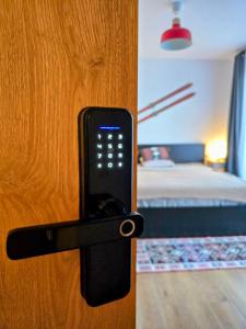 a cell phone is attached to a door at Vila Ferdinand Apartments in Sinaia +22 photos