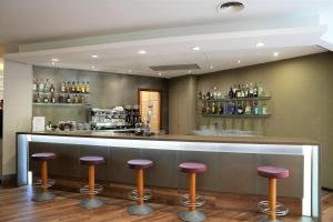 a bar in a restaurant with stools at Port Feria Valencia in Valencia
