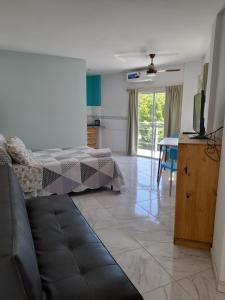 a bedroom with a bed and a living room with a table at departamentos sebas llanoo san rafael PLENO CENTRO in San Rafael