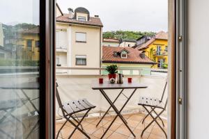 a table on a balcony with a view of a building at Heart Apartment in Merano