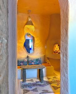 a room with a bench and a chandelier at Casa Amina in Chefchaouene