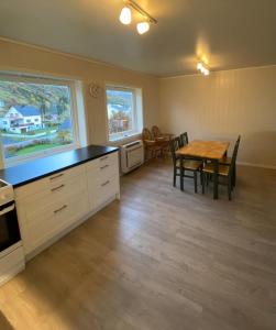a kitchen with a table and a dining room at Inger- og Petterhuset in Sørvågen +14 photos