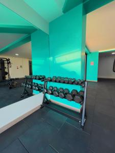 a gym with two rows of dumbbells in a room at Torre Gante Departamento de Lujo in Quito +42 photos
