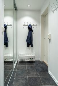 a walk in closet with a glass wall at Northstay - City Square in Tromsø +2 photos