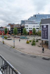 a city street with a park in front of a building at Northstay - City Square in Tromsø