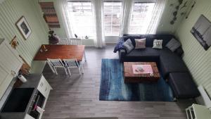 a living room with a couch and a table at Carpenters Rorbu in Leknes +7 photos