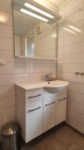a bathroom with a sink and a mirror at Carpenters Rorbu in Leknes