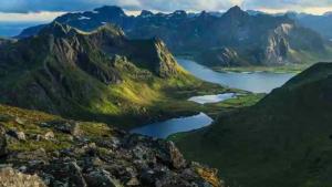 a view of a mountain range with a lake at Leilighet med balkong og havutsikt på Napp. in Napp