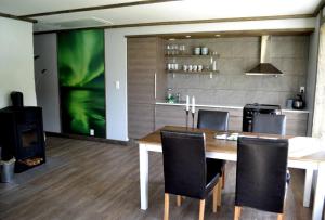 a dining room with a table and chairs and a tv at Fredvang Seahouse, apartment A in Fredvang +9 photos