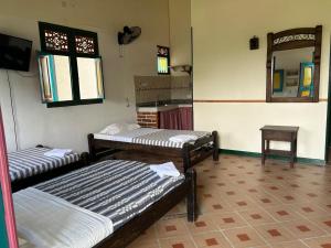 Letto o letti in una camera di FINCA HOTEL TRADICION CAFETERA