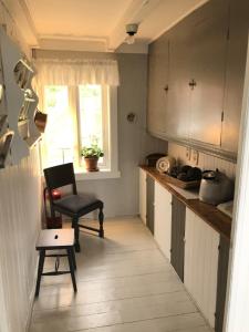 GravdalにあるVettingstua, beautiful house down by the sea.のキッチン(椅子、テーブル付)、窓