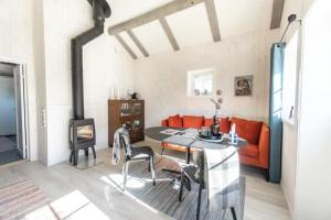 a living room with a table and a fireplace at Madelhea Cabin- Seaview Lodge in Reine