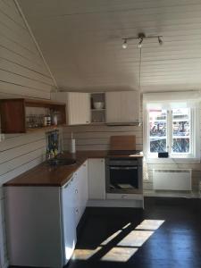 a kitchen with a counter and a sink and a window at Rindebua in Stamsund +17 photos