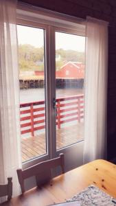 a room with a window with a view of a dock at Rindebua in Stamsund