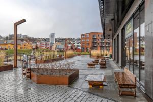 a group of benches sitting outside of a building at Arctic Escape - Central Design Apartment in Tromsø