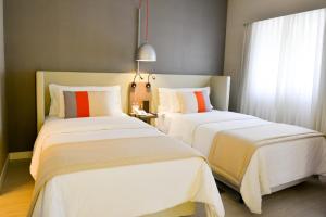 Letto o letti in una camera di Clarion Faria Lima