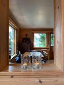 a dining room with a table with candles on it at Northern Light Cabin Lofoten in Sennesvik +17 photos