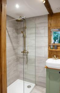 a bathroom with a shower and a sink at Hayne Barn Estate - Luxury Lodges with private hot-tubs- The studio-loft is without hot-tub in Hythe +180 photos