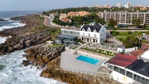 an aerial view of a house next to the ocean at Farol Hotel in Cascais