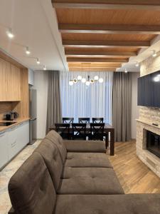 a living room with a brown couch and a table at Апарт Злата in Bukovel