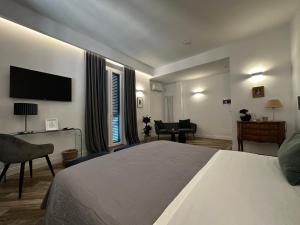 a bedroom with a large bed and a television at All Comfort Astoria Palace in Rome