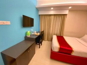 a hotel room with a bed and a desk with a computer at Hotel Park Hyatt in Dhaka
