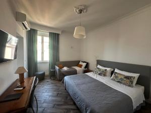a bedroom with a bed and a chair in it at All Comfort Astoria Palace in Rome +174 photos