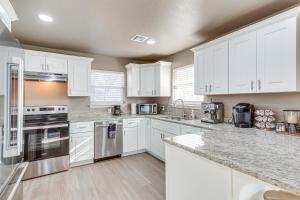 a kitchen with white cabinets and stainless steel appliances at 4 Mi to Dtwn Guthrie Family Home with Fire Pit! in Guthrie