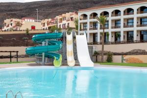 莫罗德哈布雷Hotel LIVVO Jandía Golf的游泳池中间的水滑梯