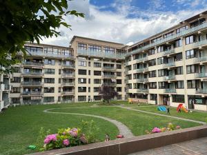 a large apartment building with a park in front of it at Studio near Copou Hospitals IRO Parhon in Iaşi