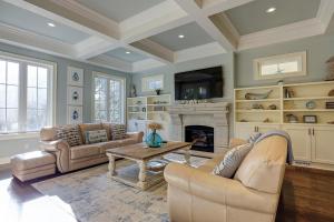 a living room with two couches and a fireplace at New Listing 5 BR Luxury Beach Home w Private Pool Three Master Suites Granite in Hilton Head Island