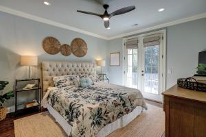 a bedroom with a bed and a ceiling fan at New Listing 5 BR Luxury Beach Home w Private Pool Three Master Suites Granite in Hilton Head Island +33 photos