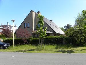 a house sitting on the side of a street at Villa Josiane in Oostduinkerke
