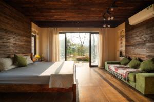 a bedroom with a large bed and a couch at Quin home, into the forest, close to Noi Bai airport in Phú Hữu