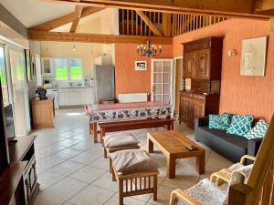 a living room with a couch and a table at Maison de charme à Saint-Géry avec piscine partagée in Saint-Géry