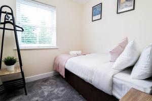 a bedroom with a white bed and a window at 3br House With Parking Near Iron Pier Thames River in Woolwich