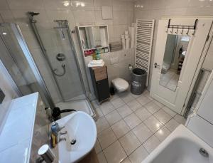 a bathroom with a sink and a shower and a toilet at Terassen Whg 68 qm bis 6 pers in Wiesbaden +13 photos
