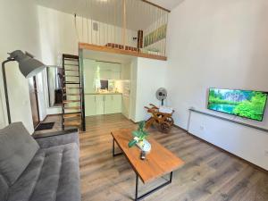 a living room with a couch and a table at Z6 Loft Apartment in Klaipėda