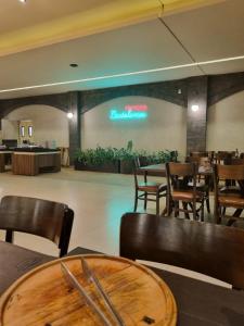 a restaurant with tables and chairs and a sign on the wall at Praias do Lago in Caldas Novas