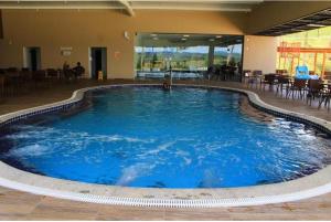 a large pool of blue water in a building at Praias do Lago in Caldas Novas +15 photos