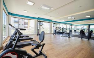 a gym with treadmills and exercise bikes in a room at Praias do Lago in Caldas Novas