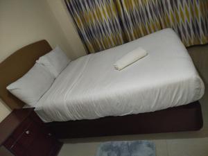 a bed with a paper roll on top of it at Urban retreats ELD in Eldoret