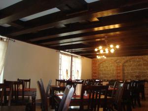 a dining room with tables and chairs and a chandelier at Pension Casa Iurca in Sighetu Marmaţiei