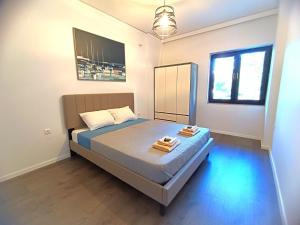 a bedroom with a bed with two towels on it at Casa Dina Nea Chora in Chania Town