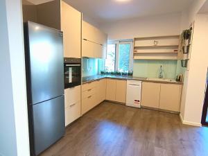 a kitchen with white cabinets and a stainless steel refrigerator at Casa Dina Nea Chora in Chania Town