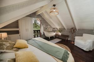 una camera con letto, sedia e vasca di Viewpoint Estate Accommodation a Haenertsburg Altre 224 foto