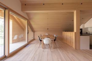 a kitchen and dining room with a wooden table and chairs at Beerenhus in Au im Bregenzerwald