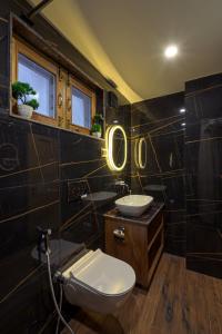a bathroom with two sinks and a toilet in it at PalPenzy - Bespoke Premium Stay in Srinagar