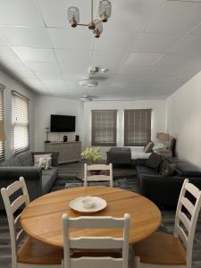 a living room with a table and a couch at Modern Studio Flat in Bramhall in Bramhall